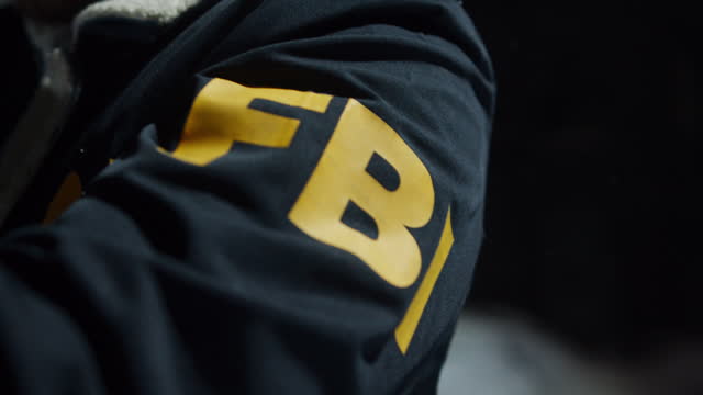 Close-up of the sleeves of the jacket with the inscription FBI