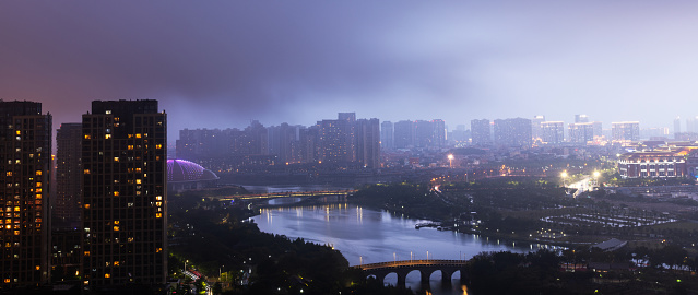 Aerial view of city buildings at dusk.