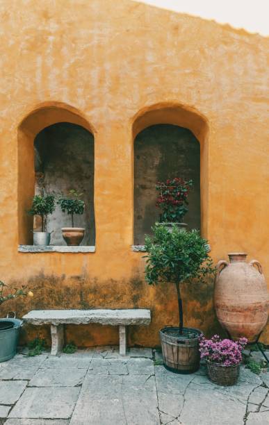 istock Ancient orange building with old amphora and potted plants 1470172232