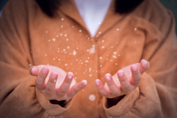 istock light in hands and magic in woman hands on dark background 1470172383