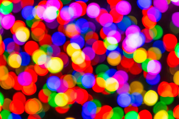 Rainbow confetti of light on black background