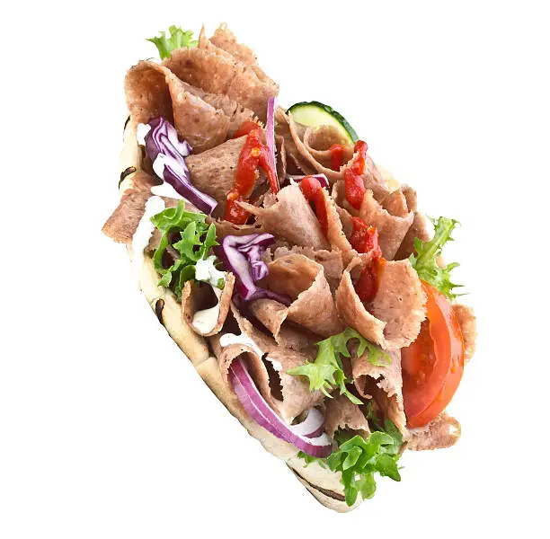 Doner Kebab Gyros on white back ground with salad and Chile Sauce.