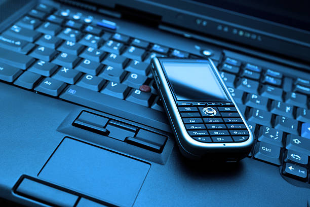 istock Blue-toned Connect. Laptop and smartphone 147019285