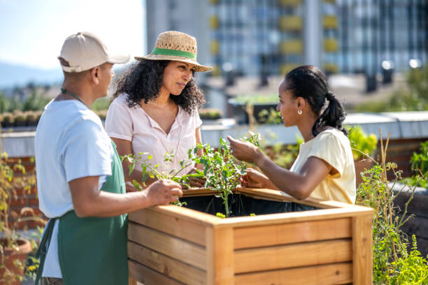 istock Man and women talking while standing by flowerbed 1470196078