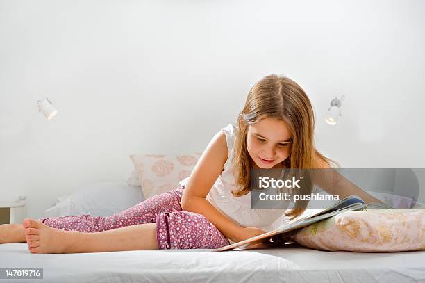 Girl Reading In Bed Stock Photo - Download Image Now - Bedroom, Book, Child