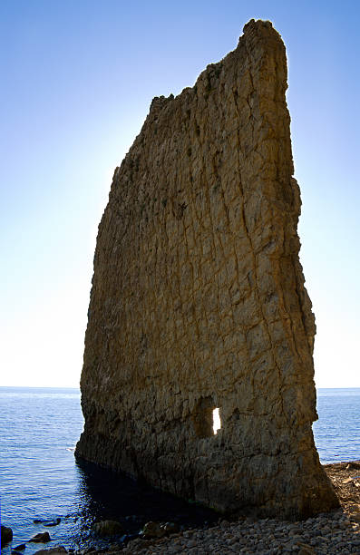 Lonely flat rock in the sea stock photo