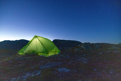 Tent at night in the Trolltinden mountain range, Norway