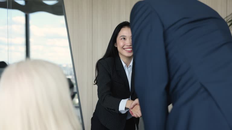 Asian female applicant answers questions, passes job interview successfully