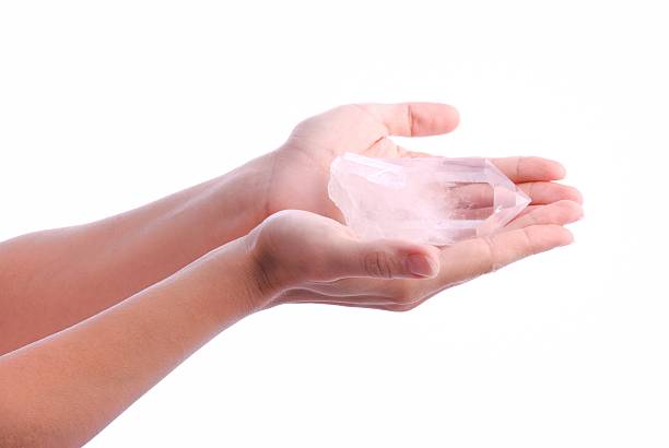 Hands holding quartz crystal stock photo