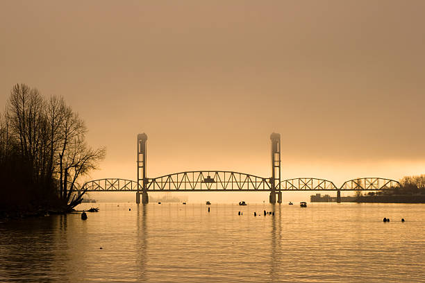 puente de celosía al amanecer - railroad crossing bridge river nautical vessel fotografías e imágenes de stock