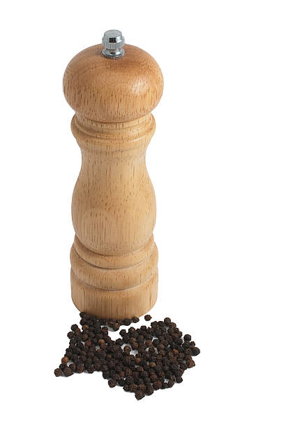istock Wooden pepper mill with beans isolated in white background 147020692
