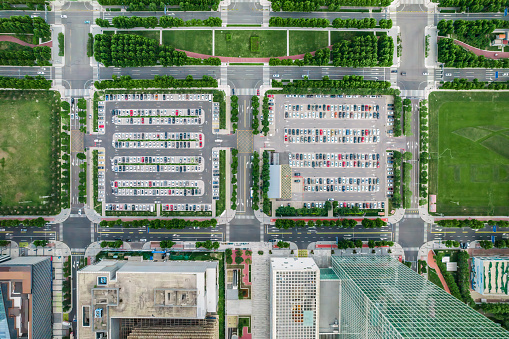 Car traffic transportation on road intersection, skyscraper buildings, condominiums in financial business or residential district at Hong Kong island. Drone aerial cityscape top view. Asia transport