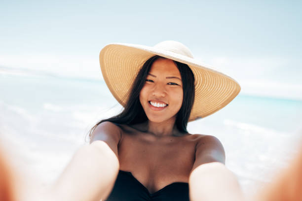 chinese tourist take a selfie at the beach