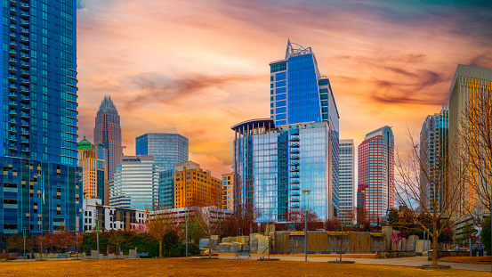 Charlotte North Carolina City skyline in spring with skyscrapers, buildings, and dramatic sky, modern metropolitan park cityscape at sunset