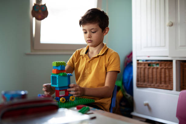 istock Adorable boy playing with toys at home. 1470209709
