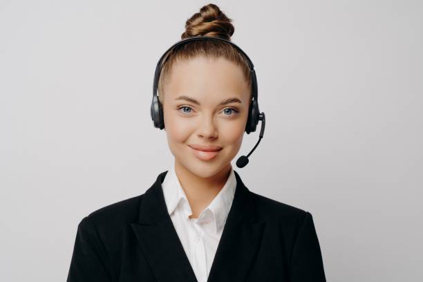 istock Female customer service representative in dark suit listening to customer 1470209847