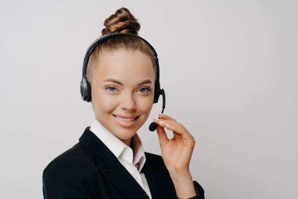 istock Female speaker with dark suit adjsting mic on headset 1470209858