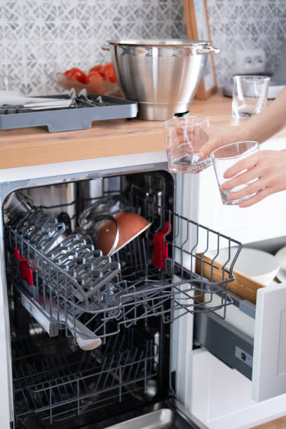 istock Women's hands sort clean dishes from the dishwasher 1470210492