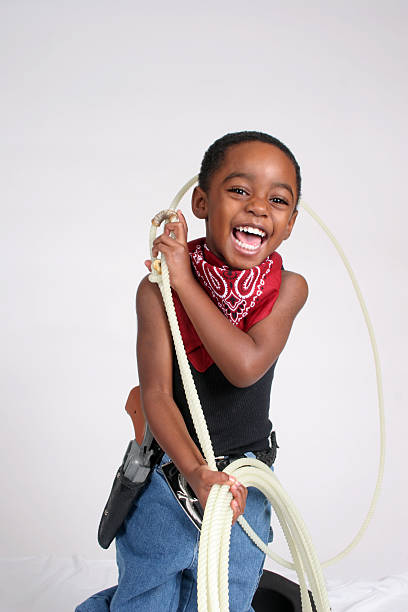 Little  happy boy in cowboy costume on the white background