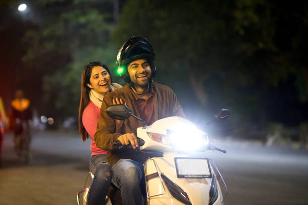 istock Happy couple enjoying motorcycle ride at night 1470210822