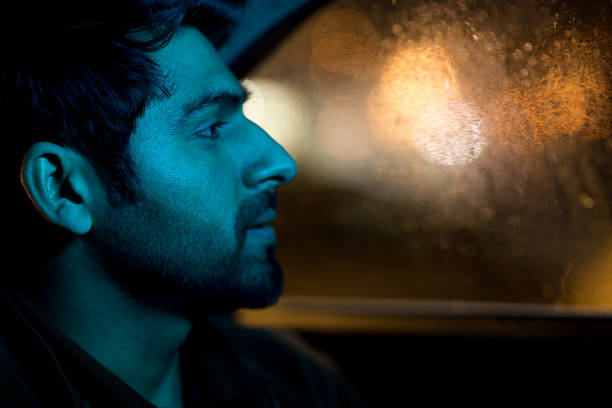 istock Happy man looking through glass window of car 1470211050