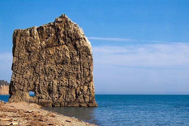 Lonely flat rock in the sea stock photo