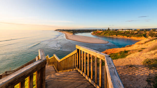 South Port beach boardwalk viewed towards Onkaparinga River South Port beach boardwalk viewed towards Onkaparinga River at sunset, South Australia peninsula stock pictures, royalty-free photos & images