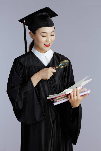 Happy new graduate holding different signs. Need a Job, Hire Me, Thank You