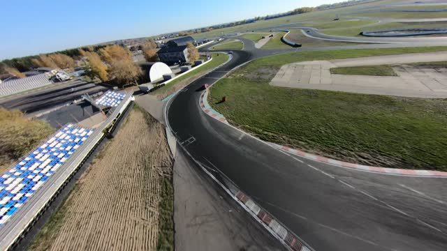 aerial filming of a circuit race on an asphalt circuit, fpv