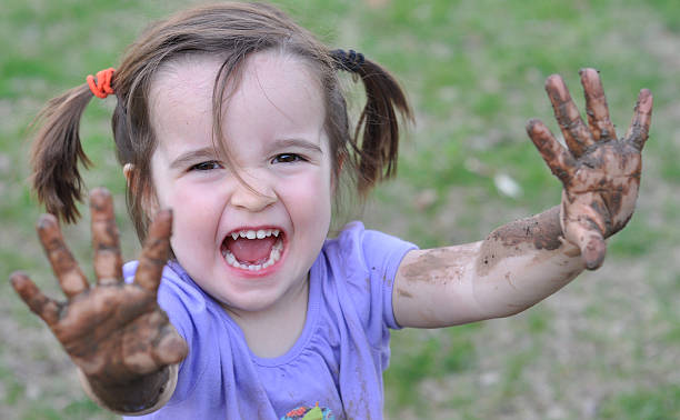 istock Little Girl with Muddy Hands 147021528