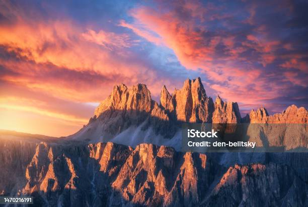 Rocky Mountains At Amazing Colorful Sunset In Summer In Dolomites Italy Mountain Ridges And Beautiful Sky With Pink Red And Ornage Clouds And Sunlight In Spring Landscape With Rocks Mountain Peak Stock Photo - Download Image Now