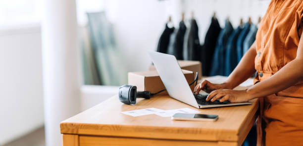 istock Online store owner using a laptop in her shop 1470216654