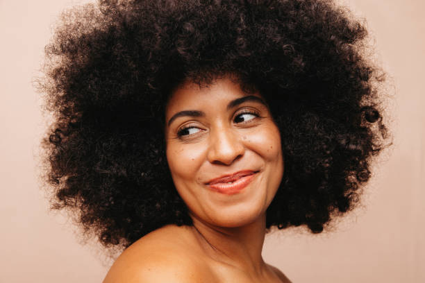 istock Self-confident woman with Afro hair smiling in a studio 1470216744