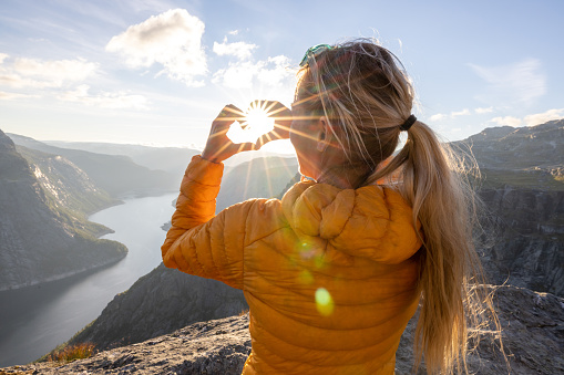 She stops to enjoy the beautiful panorama, Norwegian mountains and fjords