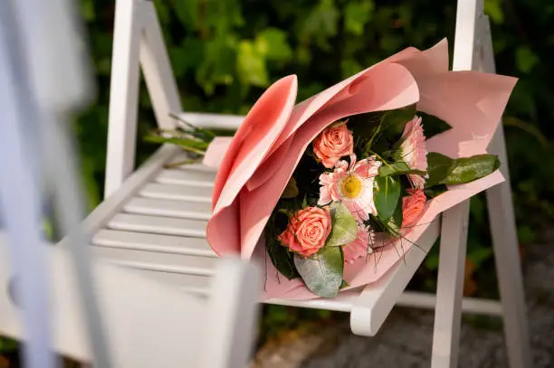 flowers bouquets bouquets and boutonnieres bouquet of roses lying on a white chair outdoors