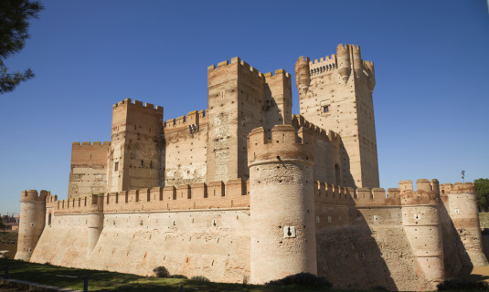 Exterior view of the Alcazar of Segovia, Spain. Tourists on the way visiting the castle.