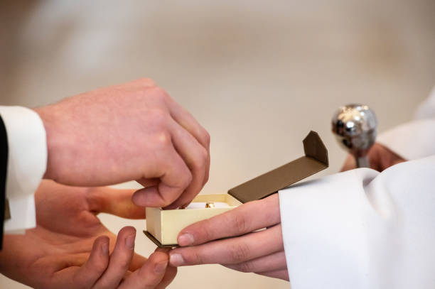 hands, wedding rings and marriage vows hands, wedding rings and marriage vows the groom takes a wedding ring from the box religious occupation stock pictures, royalty-free photos & images