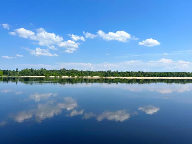 istock Summer landscape with blue river, sky and sandy beach. 1470220937
