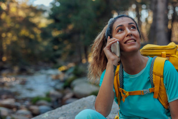 istock Female hiker using cellphone in the wood 1470221244