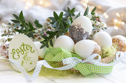 Close-up, decorative Easter eggs and flowers on a blurred background.