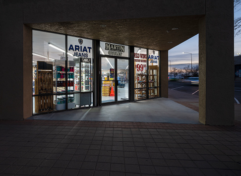 Hobbs, New Mexico, United States – February 17, 2023:  Evening view of the entrance of Martin Boot Company outlet store in downtown