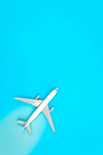 istock White plane, airplane on a blue background, flat lay, copy space. 1470222337