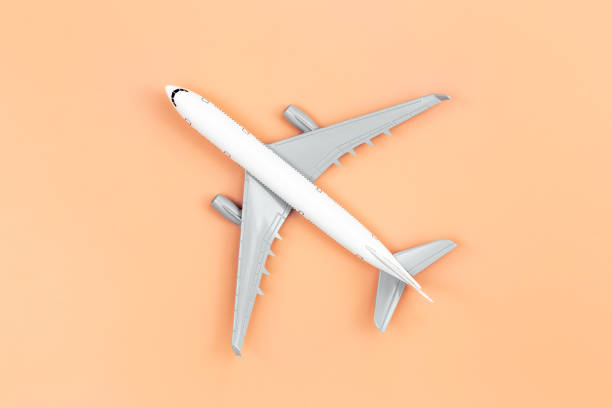 istock Airplane on orange background, flat lay, travel concept. 1470222340