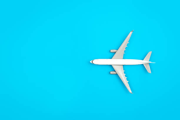 istock White plane, airplane on a blue background, flat lay, copy space. 1470222345