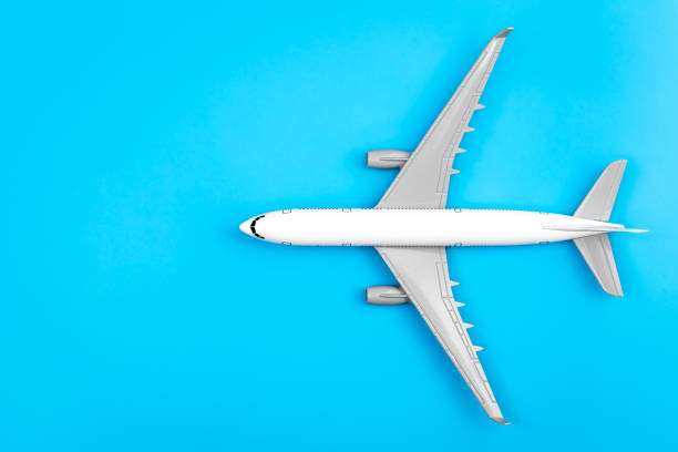 istock White plane, airplane on a blue background, flat lay, copy space. 1470222347