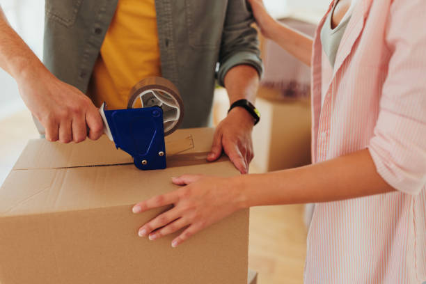 istock Couple packing cardboard box. 1470222383