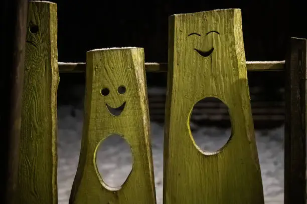 funny faces cut in wooden boards