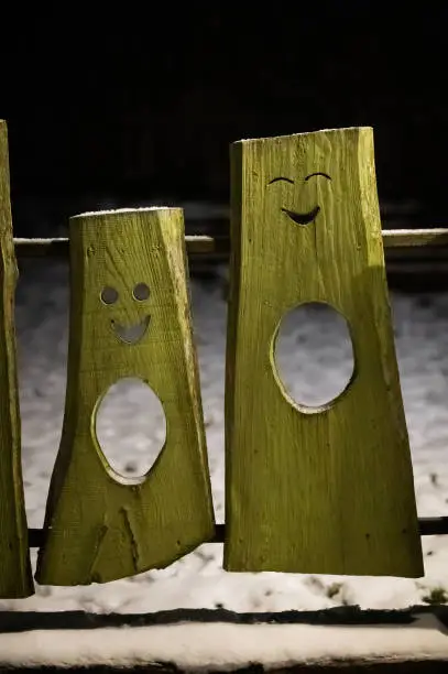 funny faces cut in wooden boards