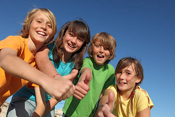 group of kids with thumbs up stock photo