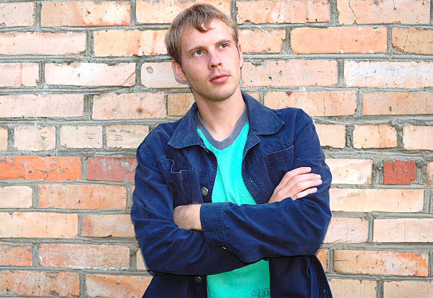 istock Young stylish man stand near brick wall. 147022427